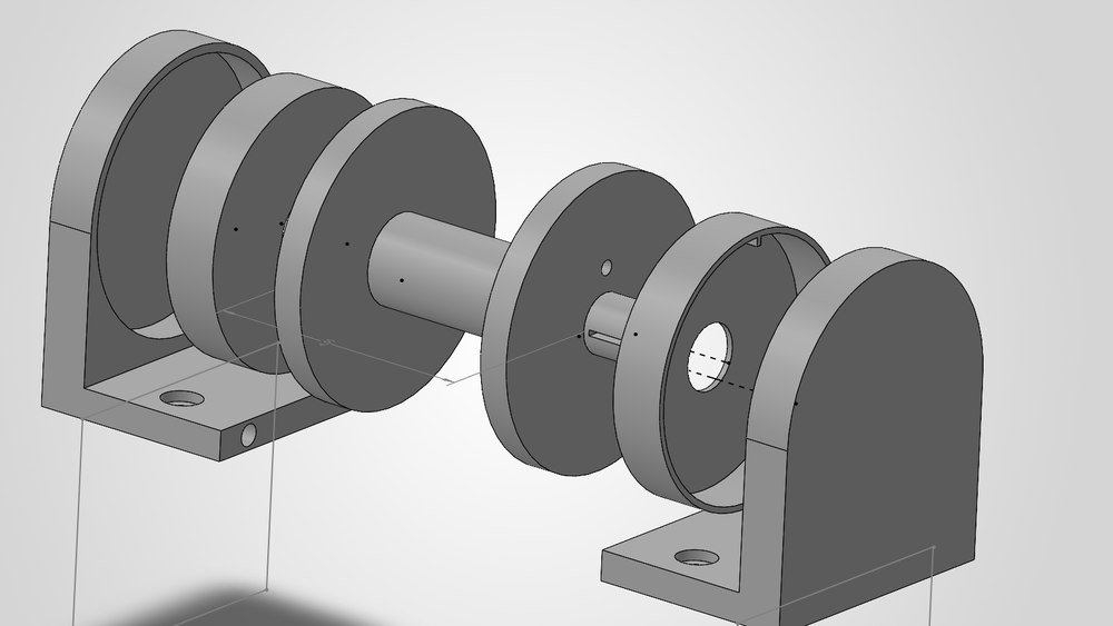 Exploded view of the spring drum subassembly: two mounting brackets, the drum flanges and the shaft separated along the shaft axis. The tape spring is housed inside the drum.